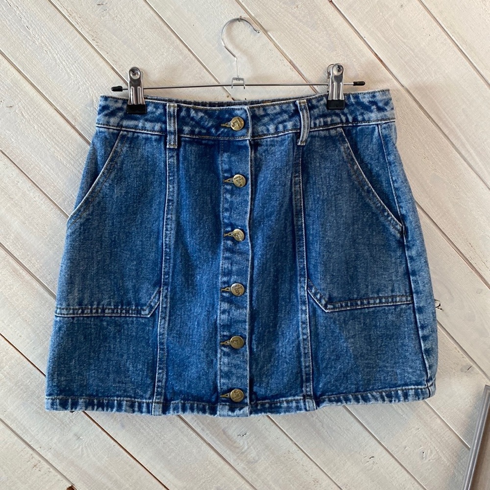 Simple but cute button denim skirt. Never worn and no flaws